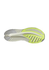 Suola della scarpa che presenta una combinazione di gomma grigia chiara e gialla neon, con una superficie testurizzata e scanalature prominenti per la trazione.
