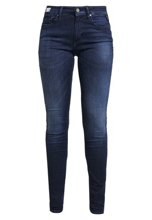 Dark blue slim-fit jeans with front pockets, belt loops, and button closure, shown against a white background.