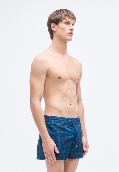 Μπλε μαγιό με σχέδιο και κορδόνι στη μέση, με λουλουδάτο μοτίβο και απαλό, υφασμάτινο ύφασμα με υφή.