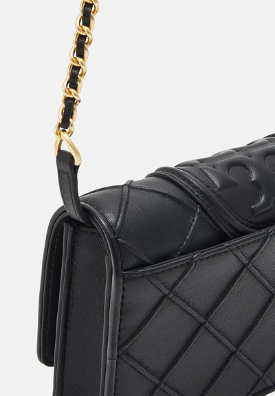 Black leather handbag with quilted pattern, featuring a gold chain strap and embossed detailing on the flap. Textured surface and structured shape.