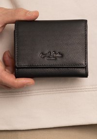 Black leather wallet with a textured finish, featuring a logo embossed on the front, folded design, and visible stitching along the edges.