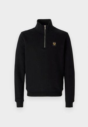 Black, zip-up sweatshirt made of cotton blend fabric, featuring a high collar, ribbed cuffs, and a gold logo patch on the chest.