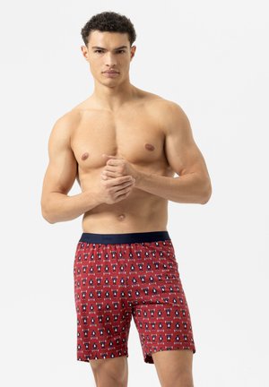 Shorts rouges avec motif de pingouins, taille élastique marine, en coton, coupe décontractée, atteignant juste au-dessus du genou.