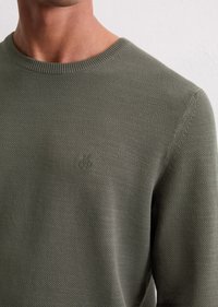 Olive green knitted crewneck sweater with a textured pattern, featuring a subtle logo embossed on the chest and ribbed neckline.