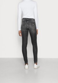 Guess Farkkuleggingsit - black denim