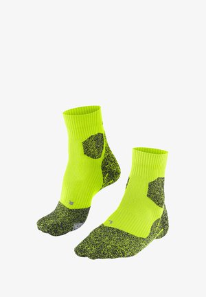 Neongelbe Knöchelsocken mit schwarzer gesprenkelter Textur und sechseckigen Akzenten. Gerippter Bund und verstärkte Zehenpartie für Langlebigkeit.