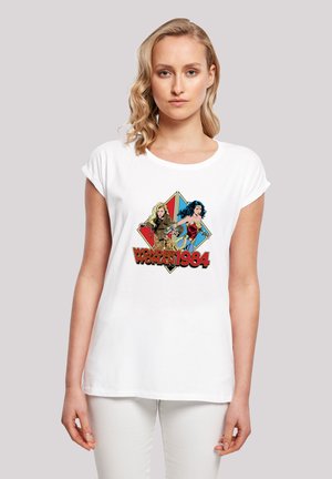 White cotton t-shirt featuring a graphic print of two characters and the text "Wonder Woman 1984" in red and yellow, with a diamond background.
