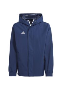 Marinblå vattentät jacka med huva, elastiska muddar och dragkedja fram. Har en vit Adidas-logotyp på vänster bröst.