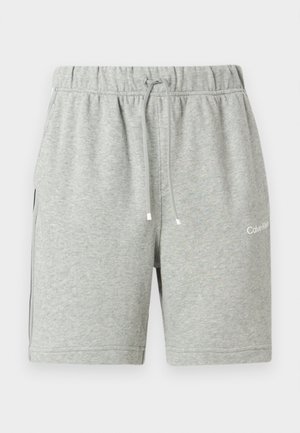 Pantaloni scurți din bumbac gri deschis, cu talie elastică, șnururi, buzunare laterale și logo Calvin Klein pe piciorul stâng.