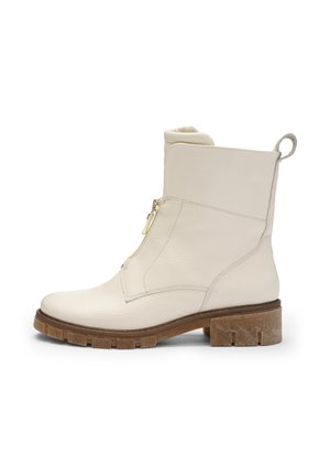 White leather ankle boot with a textured finish, side zipper, and chunky brown sole. Features a pull tab at the back for easy wear.