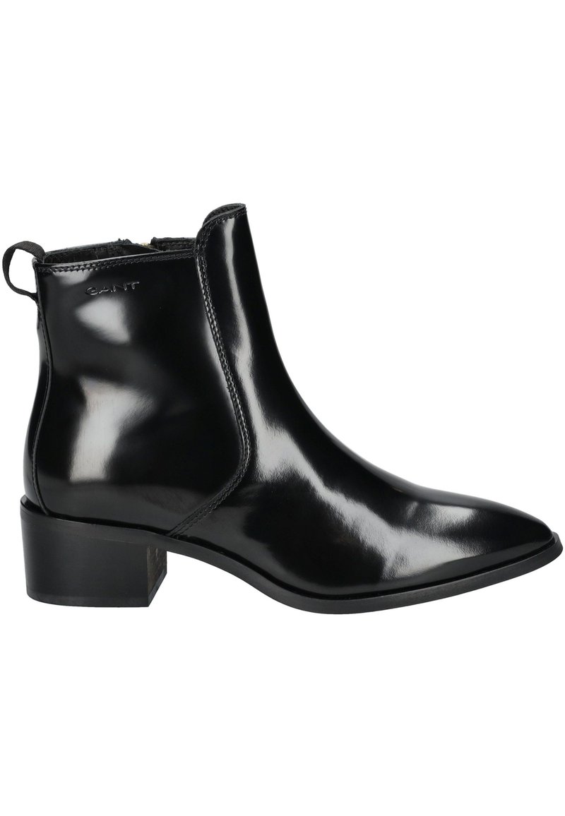 Schwarze Leder-Ankle-Boots mit glänzender Oberfläche, spitzem Zeh, niedrigem Blockabsatz und elastischen seitlichen Einsätzen für einfaches Anziehen. Mit einer kleinen Zugschlaufe.