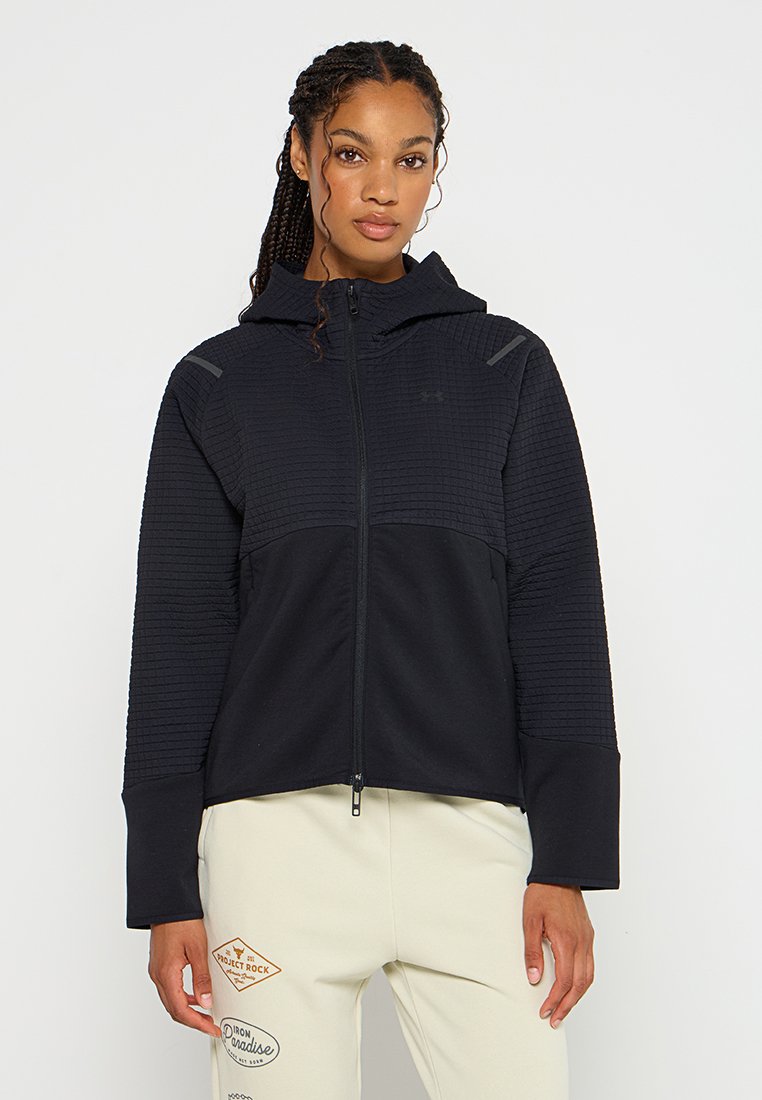 Felpa nera con zip, dotata di un pannello superiore texturizzato, una parte inferiore liscia e un cappuccio. Le caratteristiche includono una chiusura con zip e accenti discreti del logo.
