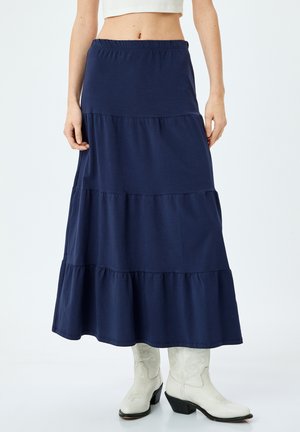 Granatowa, warstwowa spódnica maxi z miękkiego materiału z elastycznym pasem. Posiada trzy poziome falbany na krawędzi.