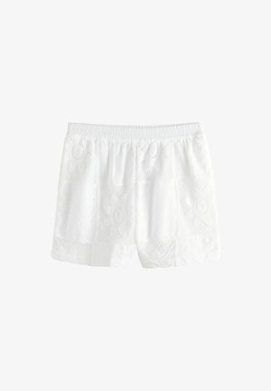 Hvide blondershorts med elastisk talje og blomsterprint på stoffet, vist mod en ensfarvet hvid baggrund.
