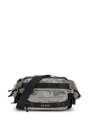 Umhängetasche mit Camouflage-Muster aus strukturiertem Stoff, ausgestattet mit mehreren Reißverschlussfächern und verstellbarem schwarzen Tragegurt. Mit "GUESS"-Logo.