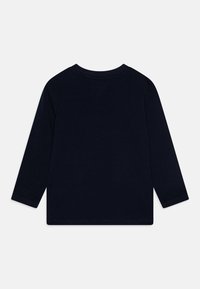 Navy blue long-sleeve shirt made from soft cotton, featuring a classic crew neckline and straight hem. No visible patterns or graphics.