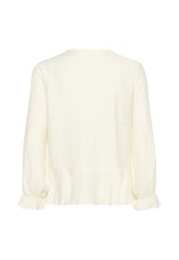 Blouse crème à manches longues avec encolure ronde, poignets à volants et un léger détail de basque, vue de dos.