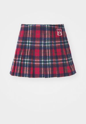 Pöttyös mini szoknya piros, tengerészkék és zöld színben, redőzött kialakítással. Oldalán piros Tommy Jeans logós folttal. Puha anyagból készült.