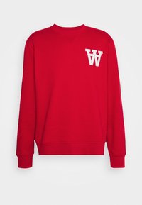 Červená mikina vyrobená z bavlněné směsi, se žebrovaným kulatým výstřihem a manžetami. Na přední straně je bílé vyšívané logo "W".