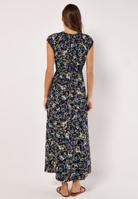 Maxi dress with a navy floral print, elastic waistband, cap sleeves, and flowy silhouette, featuring various colors in the floral design.