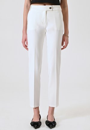 White tailored trousers with a slim fit, side pockets, and a single button closure at the waist. Smooth fabric with a crease detail.