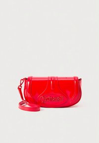 Red patent leather handbag with a curved shape, embossed logo, and a detachable strap. Features a glossy finish and structured design.