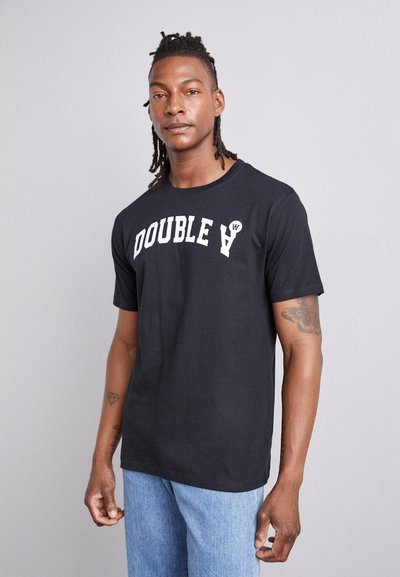 T-shirt en coton noir à manches courtes avec "DOUBLE A" en lettres blanches en gras sur la poitrine, complété par un design simple et décontracté.