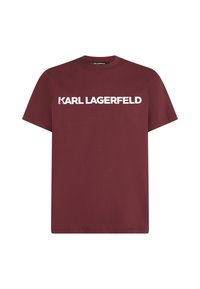 Bordo kokvilnas t-krekls ar īsām piedurknēm un apaļu kakla izgriezumu, uz kura krūtīm lieliem baltajiem burtiem ir uzdrukāts "KARL LAGERFELD".