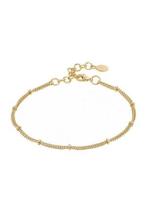 Delicate gold chain bracelet with small evenly spaced ring accents and an adjustable clasp with extension links and a round tag.