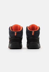 Black hiking shoes with orange accents, textured mesh panels, padded collars, and rubber soles. Features reflective stripes on sides.