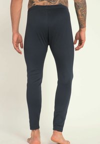 Dunkelblaue eng anliegende Leggings aus elastischem Material, mit einer glatten Textur und einem schlichten Design, tapered Bein und elastischem Bund.