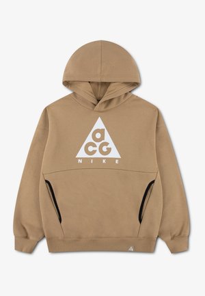 Sweat à capuche beige Nike ACG avec un logo triangle blanc et des poches latérales bordées de noir, comprenant une poche kangourou avant et une capuche.