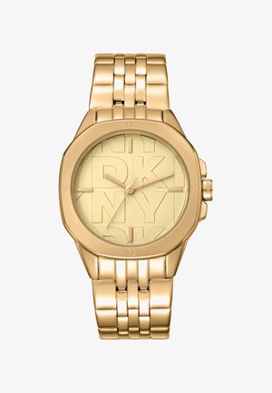 Gold-tone analog watch with a round case and a textured yellow dial featuring DKNY branding. Metal link bracelet with a polished finish.