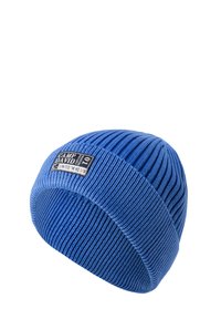 Blue ribbed knit beanie featuring a black label with white text. The hat has a snug fit and textured surface throughout.