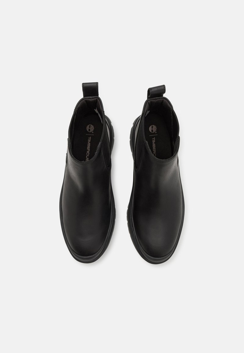 Czarne skórzane botki za kostkę z okrągłym noskiem, podwyższoną gumową podeszwą i uchwytami na pięcie. Gładka faktura z minimalnymi ozdobami.