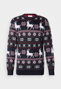 Pulôver de malha azul escuro com padrões de renas brancas, flocos de neve e padrões geométricos em vermelho, verde e branco. Decote arredondado, punhos canelados.