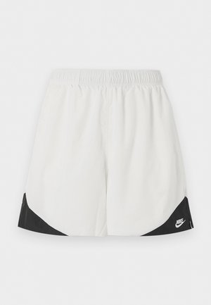 Weiße Sportshorts mit elastischem Bund und schwarzen dreieckigen Einsätzen nahe den Beinöffnungen, mit einem weißen Nike-Logo auf der rechten Seite.