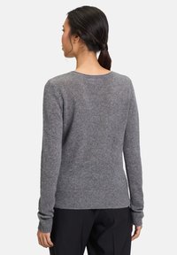 Szary wełniany sweter z długimi rękawami, prążkowanymi mankietami i dołem, dekolt w łódkę, charakteryzujący się miękką fakturą i luźnym krojem.