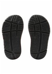 Black rubber shoe soles with textured tread pattern. Includes grooves and ridges for grip, featuring a symmetrical design.