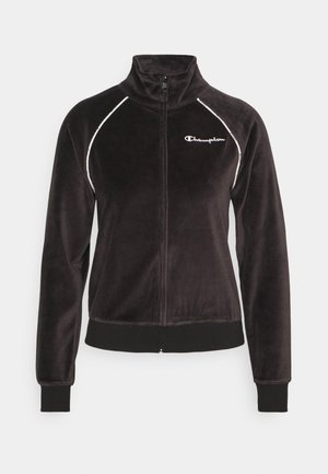 Zwarte velours jas met rits, hoge kraag, witte biezen op de schouders, elastische manchetten en zoom, en Champion-logo op de linkerborst.