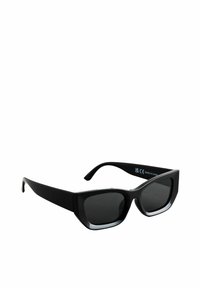 Schwarze rechteckige Sonnenbrille mit dicken Rahmen und dunkel getönten Gläsern, schräg gestellt, um die Innenseite eines Bügels zu zeigen.