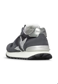 Sneaker grigio con tomaia in suede e pelle, dettaglio argentato sul tallone e suola testurizzata. Il dettaglio a forma di stella sui lati aggiunge un contrasto.