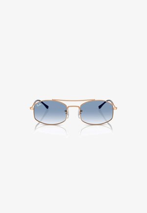 Occhiali da sole Ray-Ban con montatura in metallo dorato, lenti ovali a gradiente blu, supporti nasali e dettagli decorativi sulle tempie.
