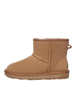 Tan ankle boot made of soft suede-like material, featuring a rounded toe, shearling lining, and a rubber sole with a heel tab.