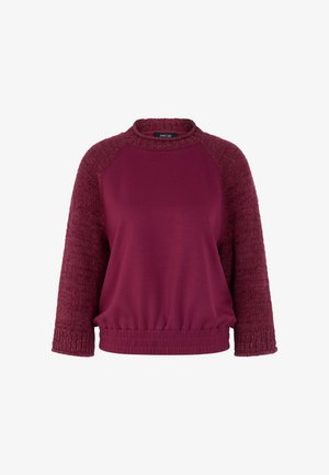 Dunkelroter Sweatshirt mit einem strukturierten, gestrickten Stoff an den Ärmeln und einem glatten Körper. Verfügt über einen runden Halsausschnitt und einen elastischen Bund.