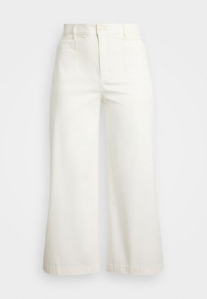 Bela široka hlače iz bombaža. Imajo visok pas, dve sprednji žepu in čisto zaključek brez vzorcev ali okraskov.