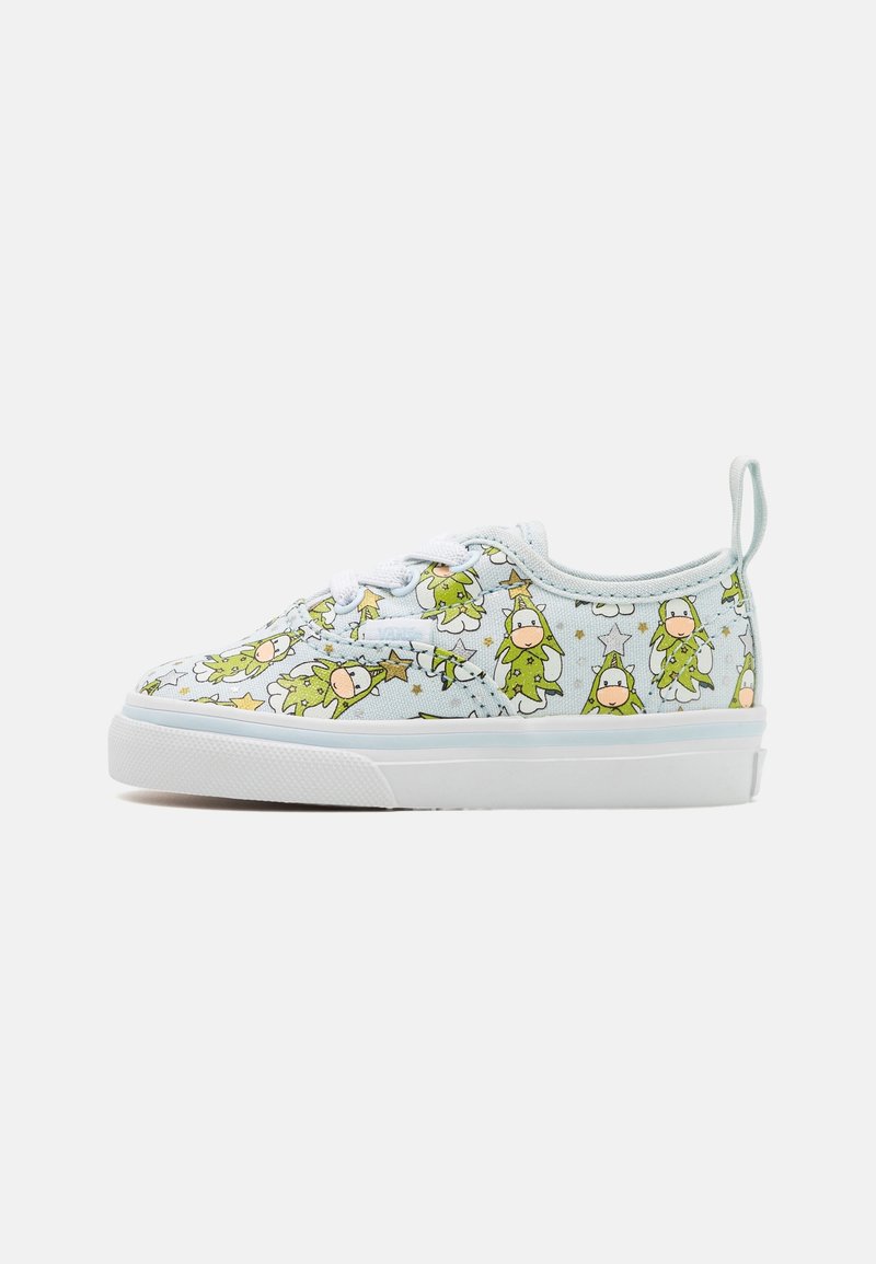Light blue canvas sneaker featuring a playful pattern of green cartoon characters and stars, with white rubber sole and lace-up design.