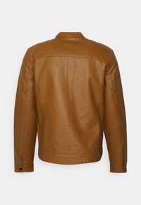 Brązowa skórzana kurtka o gładkiej teksturze, widocznych przeszyciach i prostym kołnierzu. Posiada długie rękawy oraz mankiety zapinane na zatrzaski.