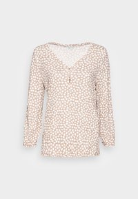 Blusa leggera a maniche lunghe, beige con motivo astratto bianco. Collo a V con tre bottoni frontali, polsini elasticizzati. Texture morbida.