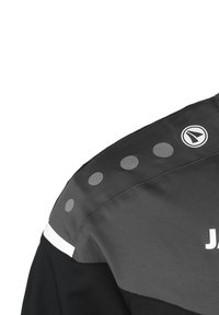Schwarze und graue Jacke mit glatter Textur, ausgestattet mit reflektierenden Punkten auf der Schulter und einem weißen Akzentstreifen unten.